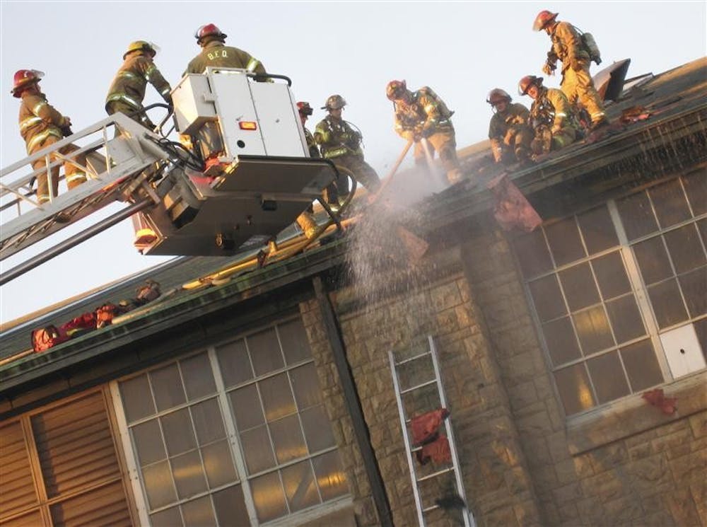 Firefighters battle a blaze atop the Ora L. Wildermuth Intramural Center on Dec. 31 at the School of Health, Physical Education, and Recreation building.