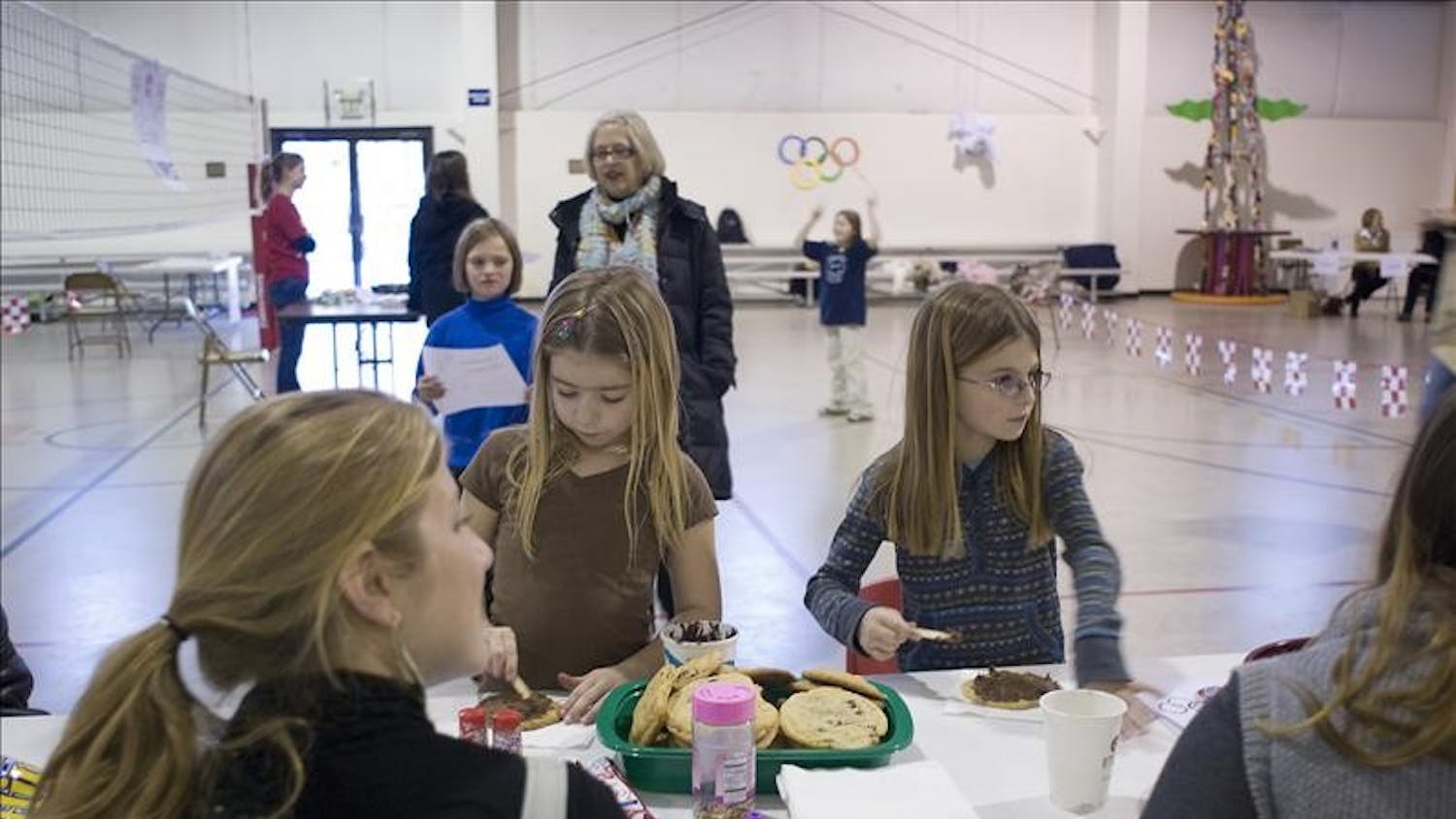 Members of Girls Inc. decorate cookies at the Chocolate Olympics Wednesday Evening.
