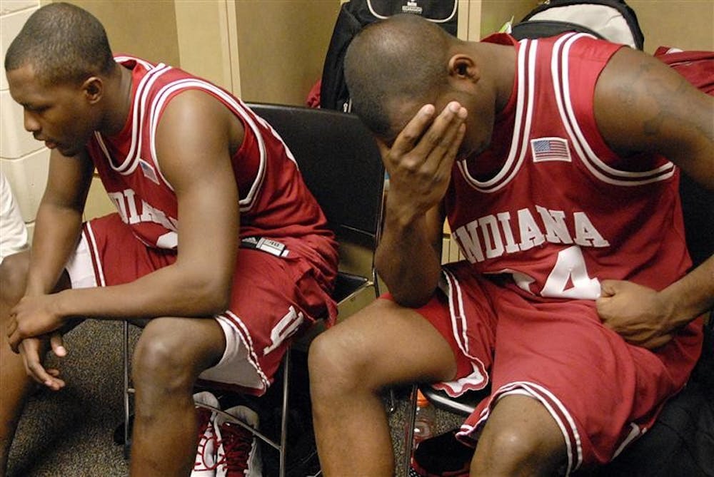 IU freshman Malik Story, right, wipes his face as teammate Nick Williams talks with a member of the media in the IU lockerroom following IU's 66-51 loss to Penn State in the first round of the Big Ten Tournament on Thursday at Conseco Fieldhouse in Indianapolis. The loss ended the worst season in the program's history.