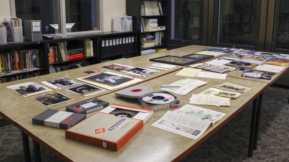 Old pictures, posters, and rolls of film are set out on the tables in the Reading Room of the Black Film Center. Located in the basement of Wells Library, the Black Film Center aims to preserve African American-made films and works with IU Cinema to showcase those works to students.