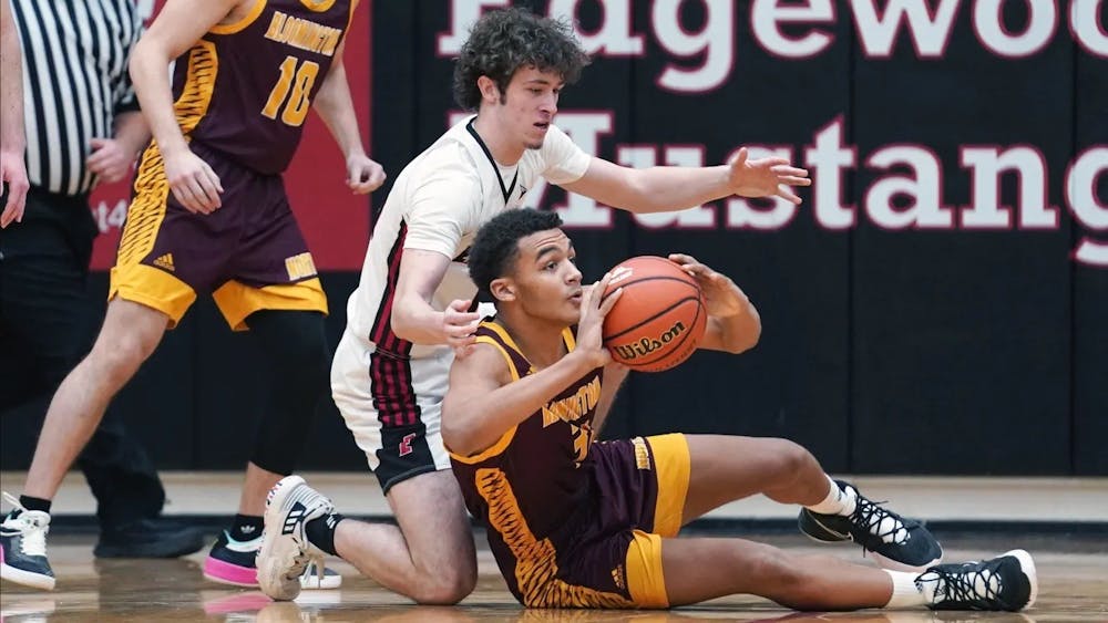 Bloomington North junior Bril Kante recovers a loose ball against Edgewood Feb. 3, 2022.