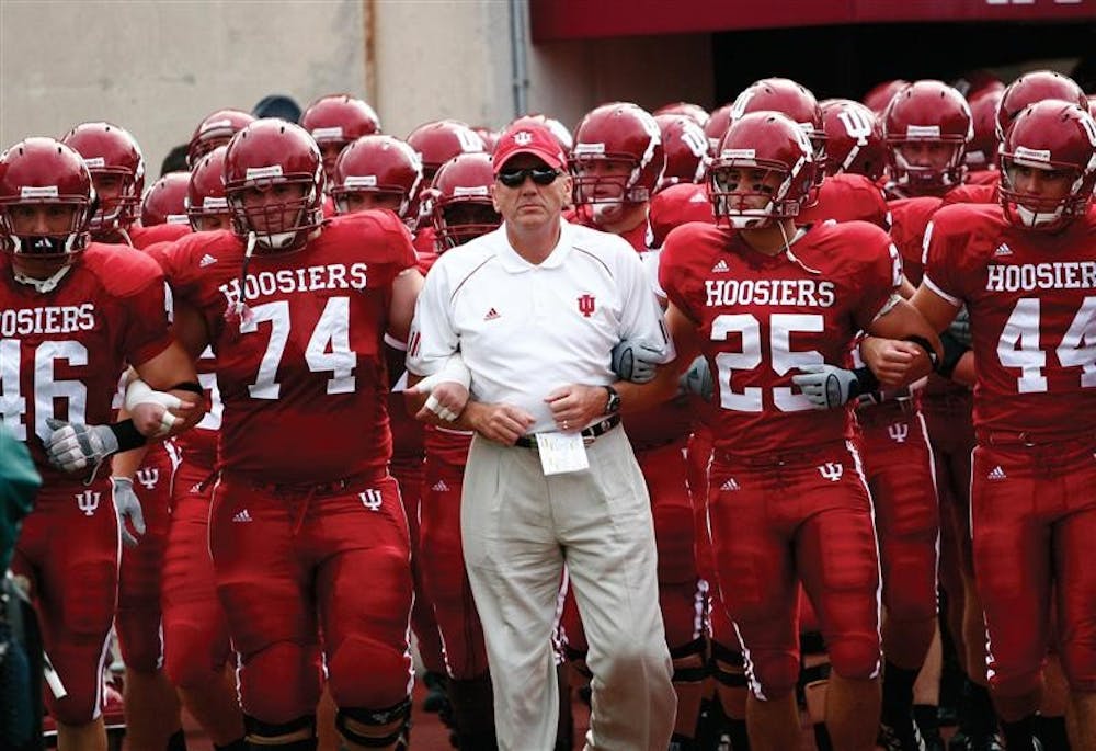 Late football coach Terry Hoeppner and his Hoosiers march onto the field prior to kickoff at Memorial Stadium.  