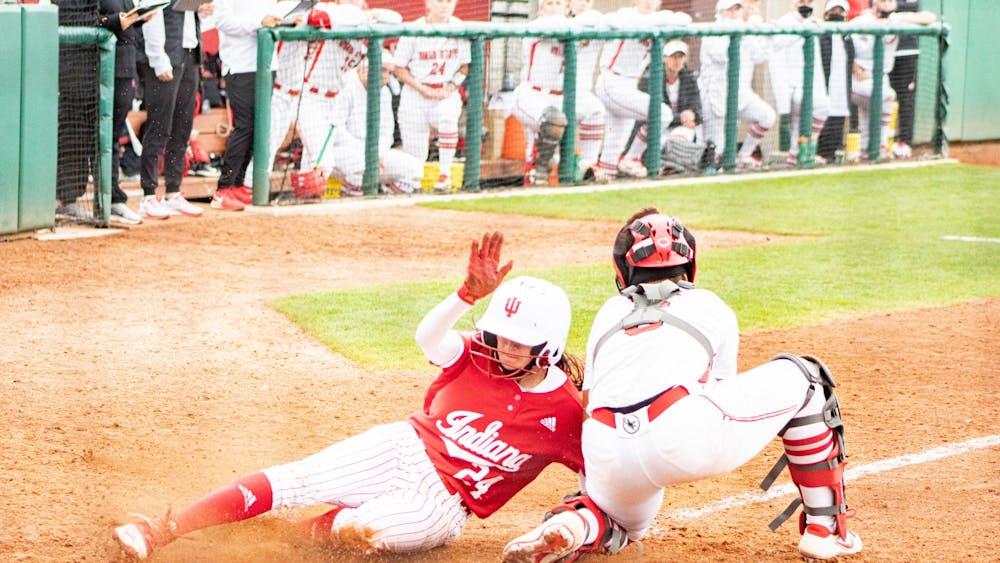 Senior outfielder Taylor Lambert slides into home plate April 17 at Andy Mohr Field. IU softball split its series with Illinois 2-2 this weekend.