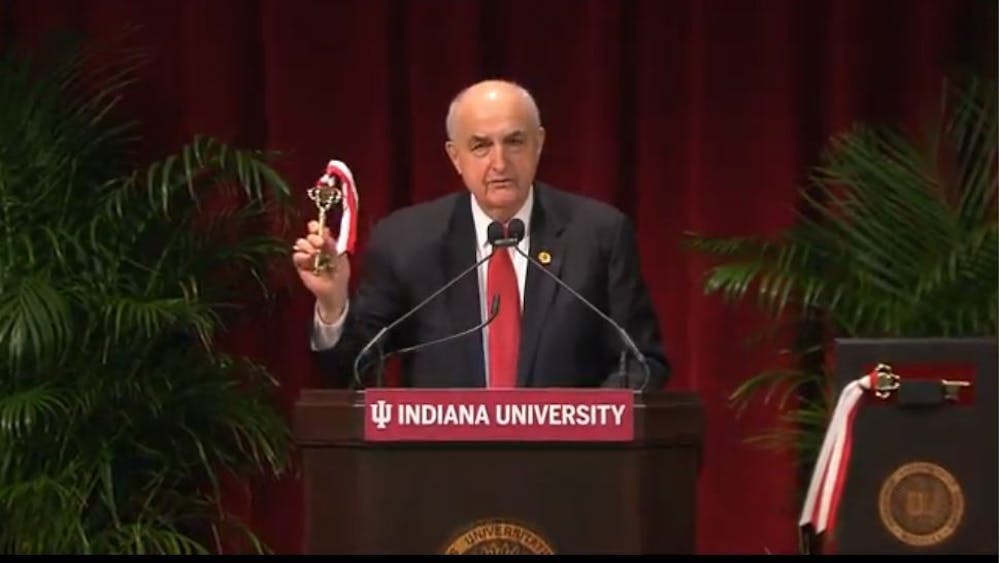 IU president Michael McRobbie holds up a symbolic key at a dedication event Wednesday. The event was McRobbie's final public event as IU's president.