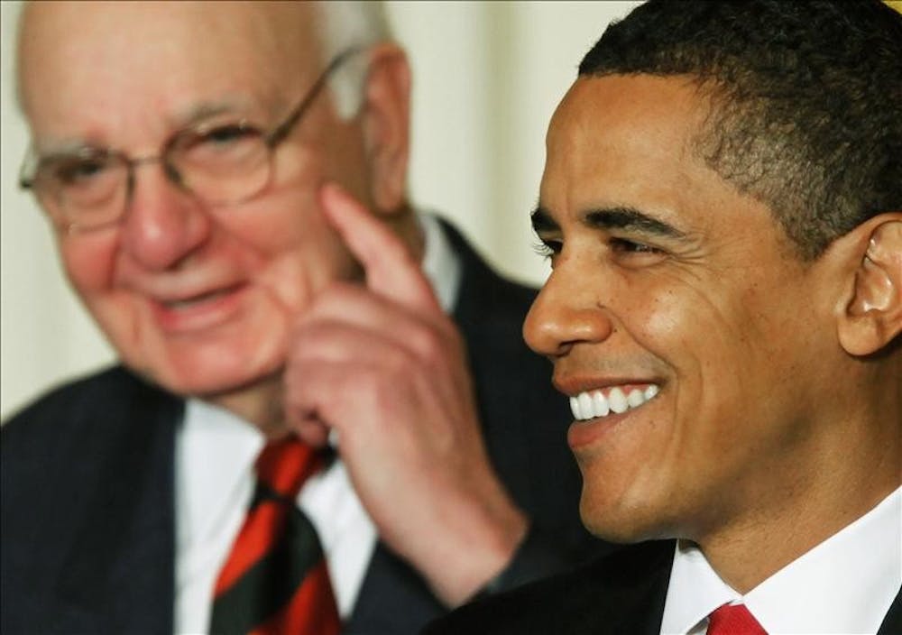 President Barack Obama, accompanied by Economic Recovery Advisory Board Chair Paul Volcker, smiles as he speaks in the East Room of the White House on Friday in Washington, where he introduced members of the President’s Economic Recovery Advisory Board. 