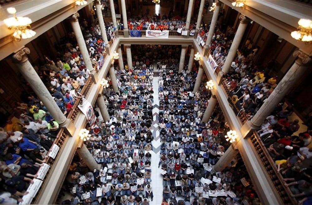 Union workers filled the rotunda to protest proposed cuts in unemployment benefits during a rally at the Statehouse in Indianapolis, Monday.  The midday rally is the largest held inside the Statehouse this legislative session. 