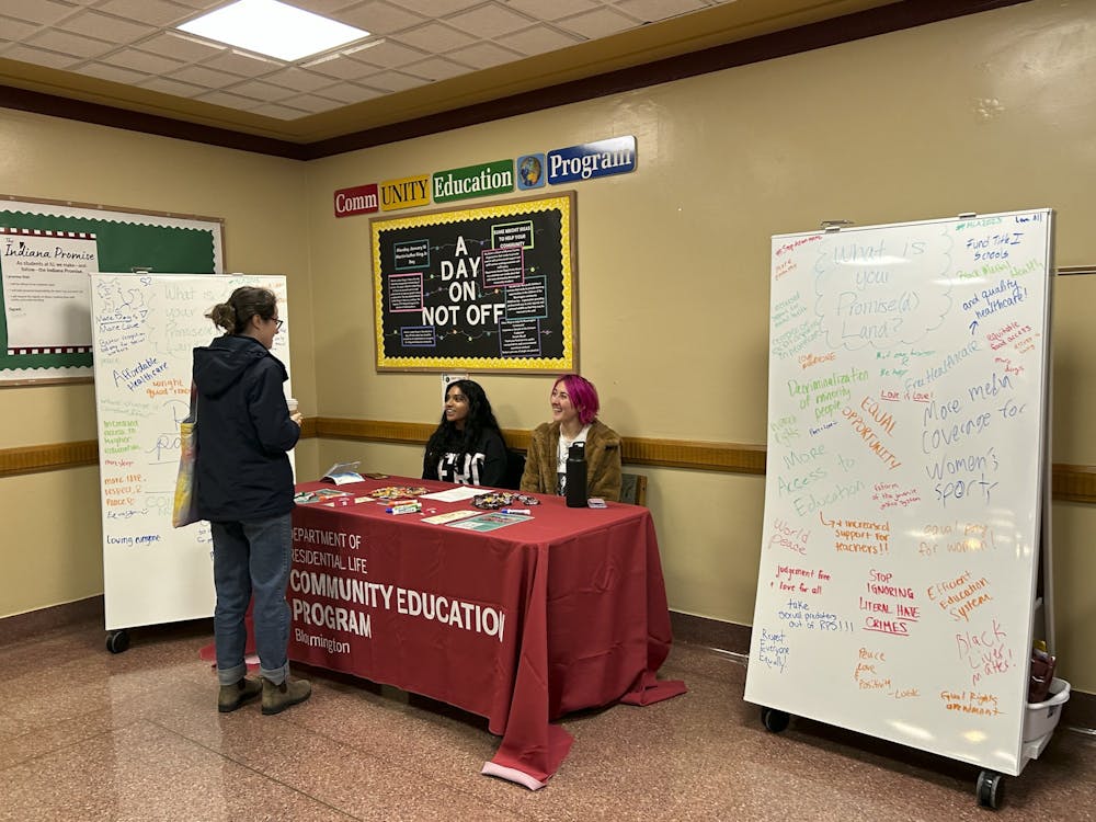 IU students Chaarvi Singh and Emily Grimaldi ask people to reimagine a better IU community as part of the CommUNITY Education Program&#x27;s 2023 Martin Luther King Jr. Civil Rights Immersion Series on Jan. 16, 2023, in Wright Quad. The theme this year was “The Promise(d) Land: Creating a more just, fairer, and equitable community.&quot; &quot;The point of this event is just to get students talking and thinking about what more equitable and just society looks like to them,” Grimaldi said. “The theme is ‘The Promised Land’ to relate to MLK day, and it is to get students talking and thinking about MLK&#x27;s Legacy and envisioning a better world for themselves.&quot;