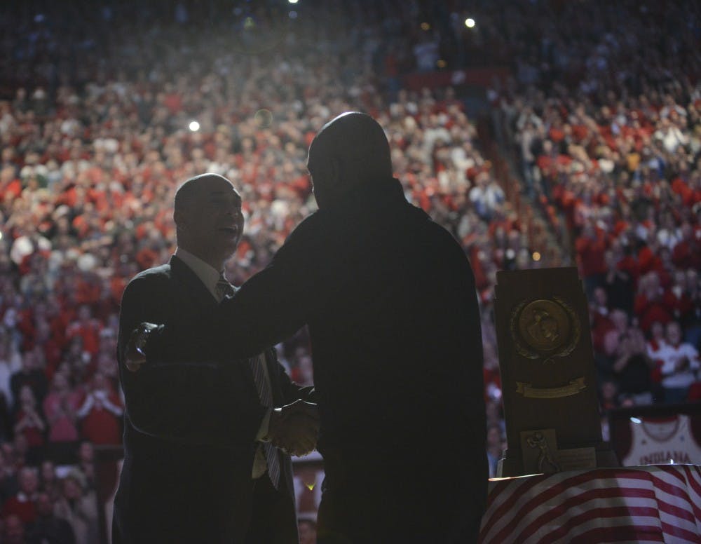 Jim Roberson (left) and Scott May (right) shake hands at halftime during the game against Wisconsin on Jan. 5, 2016 at Assembly Hall. May, a member of the 1976 National Championship team, will enter the College Basketball Hall of Fame in November.&nbsp;