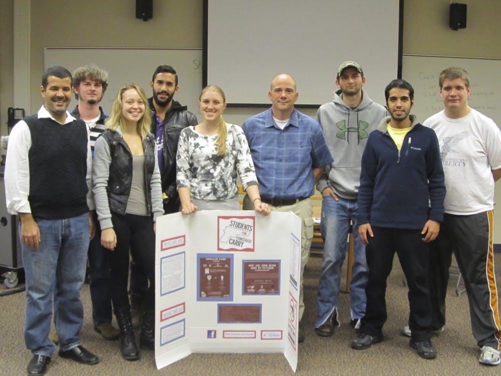 Students for Concealed Carry at IU Bloomington pose with advisor John Summerlot at a meeting. The group's next event is the National Empty Holster Protest on March 30, according to the Facebook page. 