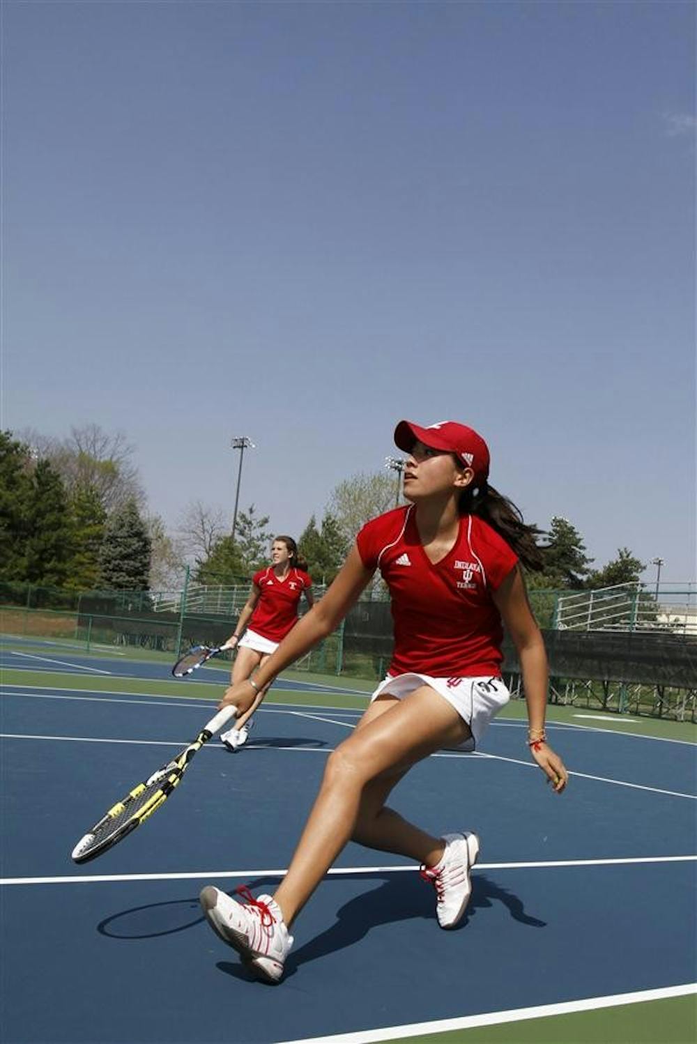 Sophomore Kayla Fujimoto (front) and senior Evgeniya Vertesheva prepare to return the ball in doubles play against the Minnesota Gophers on April 10 at the Indiana University Tennis Center. Fujimoto competed in the ITA Summer Circuit regional competition the weekend of July 30 at IU.