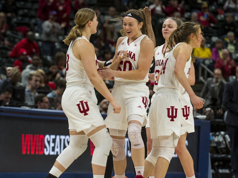 IU players celebrate after a play March 6 at Bankers Life Fieldhouse in Indianapolis. No. 4 seed IU defeated No. 5 seed Rutgers 78-60 in the quarterfinal round of the Big Ten Tournament.