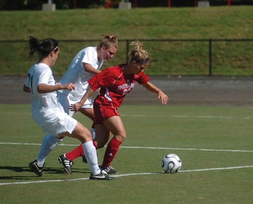 IDS File Photo
Senior forward Megan Pipkens moves past two Penn State defenders in a game at Bill Armstrong Stadium last year.  