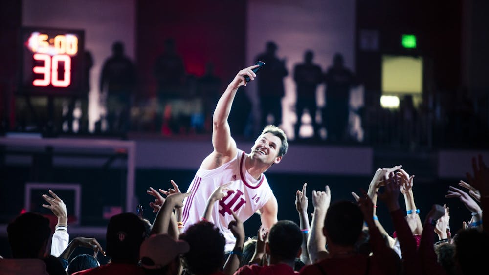 Senior forward Nate Childress takes a selfie with fans during his introduction at Simon Skjodt Assembly Hall for Hoosier Hysteria on Oct. 7, 2022. Childress is one of four walk-ons on Indiana men&#x27;s basketball this season.