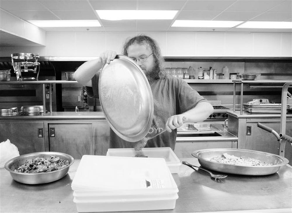In this October 2007 photo, Jonas Flanary, Bloomington resident and employee at Hoosier Hills Food Bank, collects un-served food donated by the IU Tudor Room. The food bank will have its annual meeting Friday to report 2008 activities and its expectations for 2009.