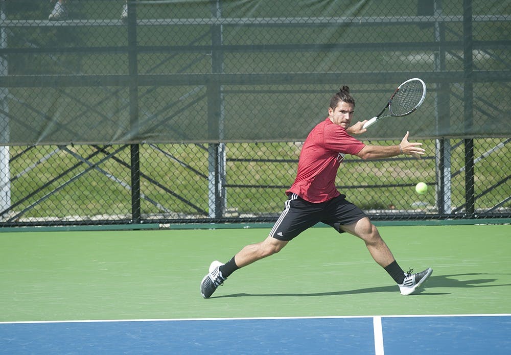 IU Junior Sam Monette hitting a forehand shot against Matt Hagan of the University of Iowa on Apr. 5 at the Varsity Tennis Courts. Monette edged his opponent and won the match 7-6, 7-6.