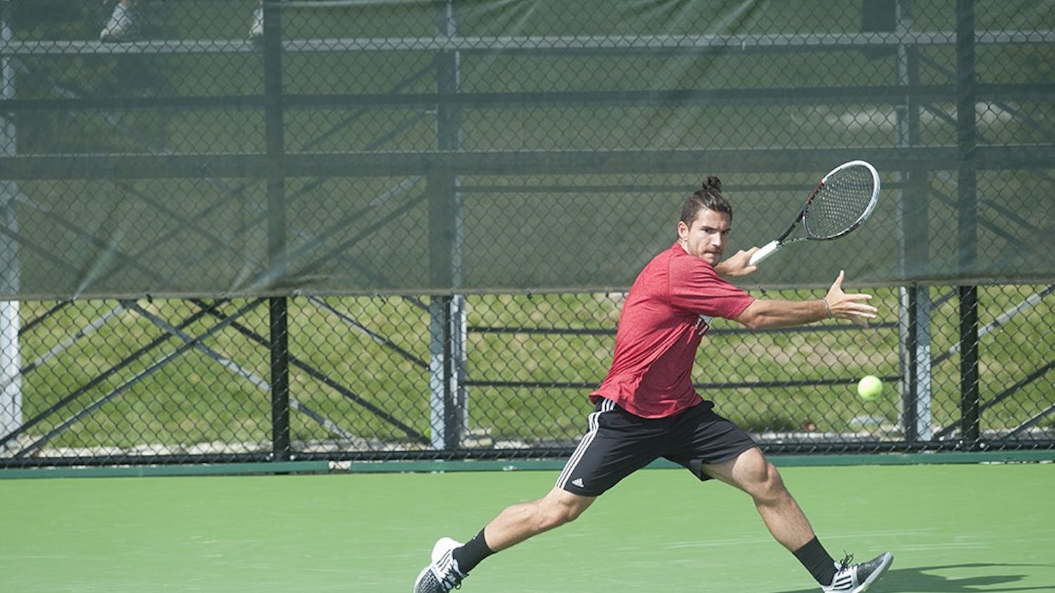 IU Junior Sam Monette hitting a forehand shot against Matt Hagan of the University of Iowa on Apr. 5 at the Varsity Tennis Courts. Monette edged his opponent and won the match 7-6, 7-6.