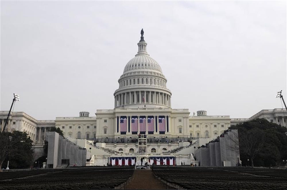 Workers put the finishing touches on the west side of the U.S. Capitol on Monday morning in Washington. An estimated one to two million people will fill the west lawn of the U.S. Capitol and the National Mall.