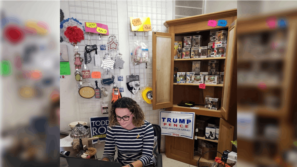 High School Republican Chair Taylor Bryant sits at a desk in the temporary office for the Monroe County Republican Party in Bloomington. 