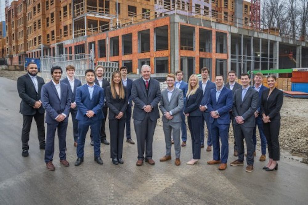 <p>Kelley students who helped establish the Sample Gates Management Inc. fund, with Doug McCoy, the Al and Shary Oak director of real estate, are pictured next to a construction site. Sample Gates Management LLC and is managed by 16 students.<br/><br/><br/><br/></p>
