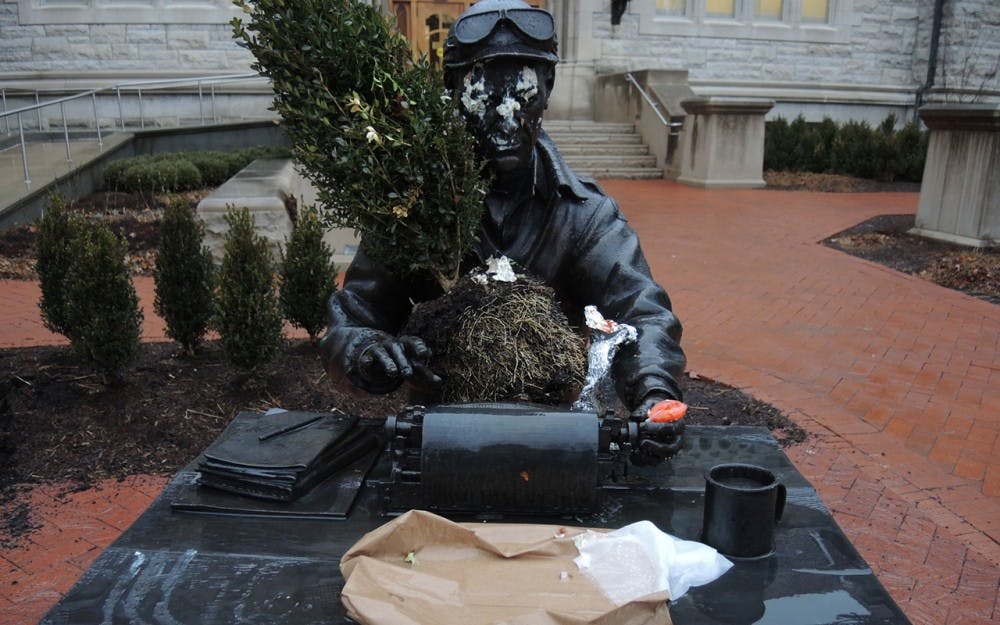 A statue of WWII Correspndent, Ernie Pyle located outside of Franklin Hall. The statue was defaced with a burrito or gyro along with an uprooted plant.
