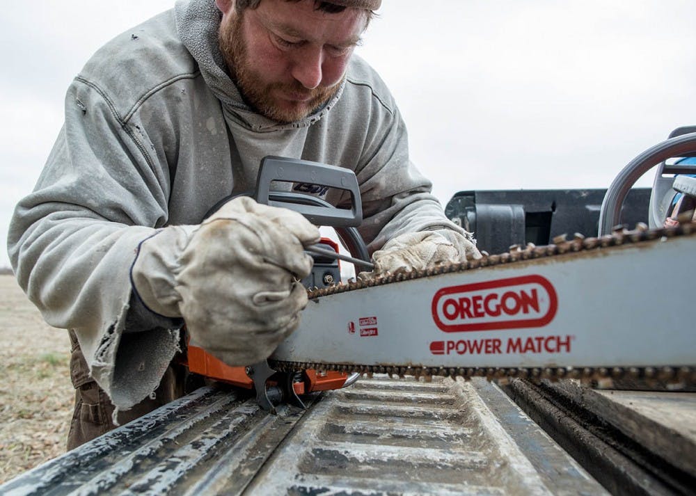 Kevin Pool sharpens the teeth on his Husqvarna chain saw shortly before setting off to cut trees down at a logging site on the east side of Indianapolis, Indiana on Dec. 2, 2106. Pool has been logging for over 30 years out of Helmsburg, Indiana.