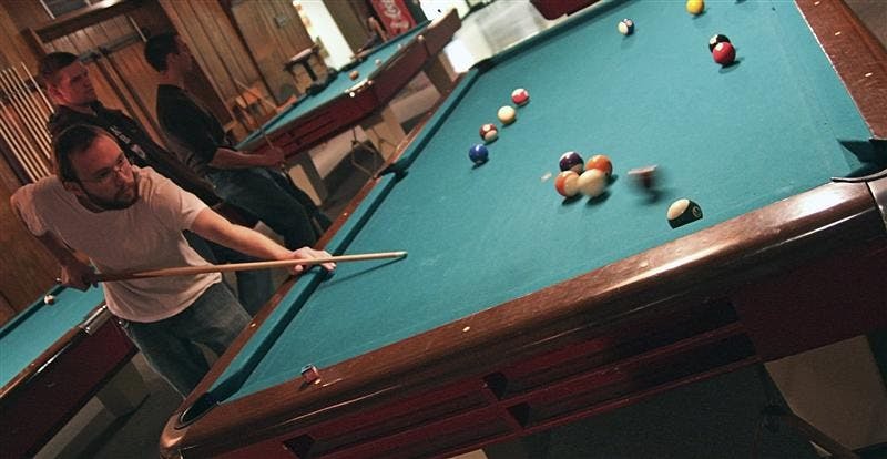 Junior James Cash fits in a game of billiards before class Monday afternoon in the IMU Back Alley. The IU Billiards Club meets Monday evening in the IMU Back Alley from 7-9.
