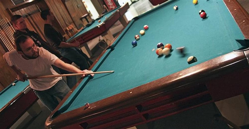 Junior James Cash fits in a game of billiards before class Monday afternoon in the IMU Back Alley. The IU Billiards Club meets Monday evening in the IMU Back Alley from 7-9.