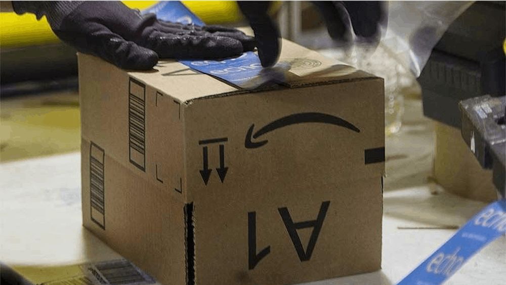 An Amazon employee assembles a box.