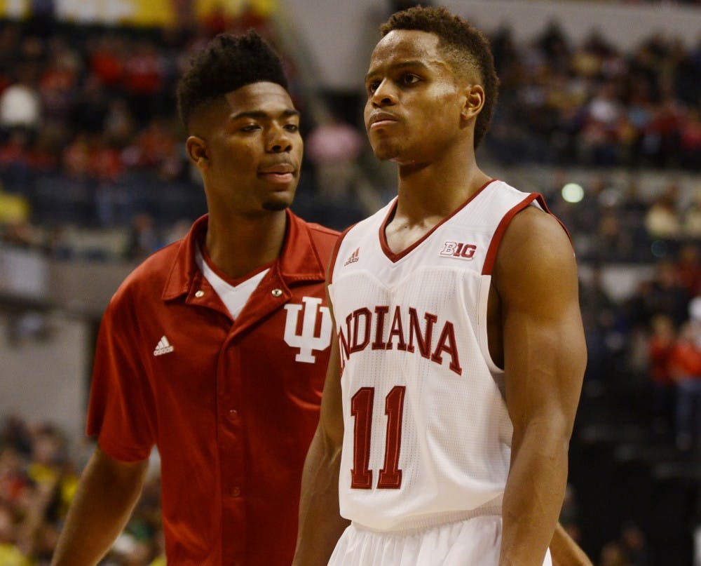 Senior guard Yogi Ferrell and sophomore guard Robert Johnson walk of the court following the 72-69 loss to Michigan in the Big Ten Tournament on Friday at Bankers Life Fieldhouse. 