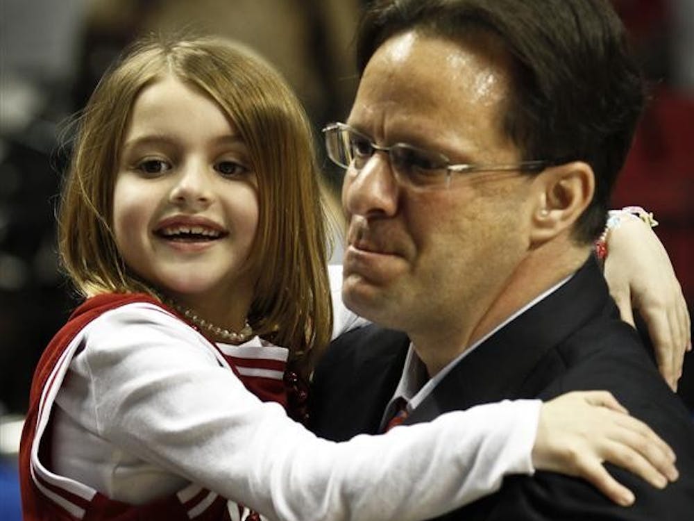 Tom Crean carries his daughter Ainsley off the court after the Hoosiers 63-61 win against VCU on Saturday during the 3rd round of the NCAA Tournament at the Rose Garden in Portland, Oregon.
