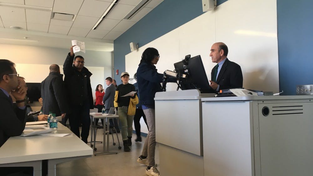 Students drop fliers as they leave Elliott Abrams' speech. The event was organized March 2, 2018, and drew heavy controversy.