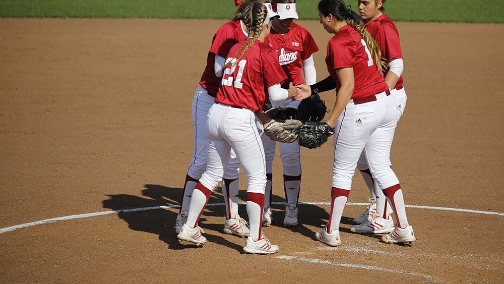 Members of the IU Softball team huddle up after Senior Pitcher Miranda Tamayo struck out an opposing player during IU's first game against Purdue Wednesday at the Andy Mohr Field. IU won 6-3 after Mena Fulton hit a 3-run home run during the last inning of the game. 