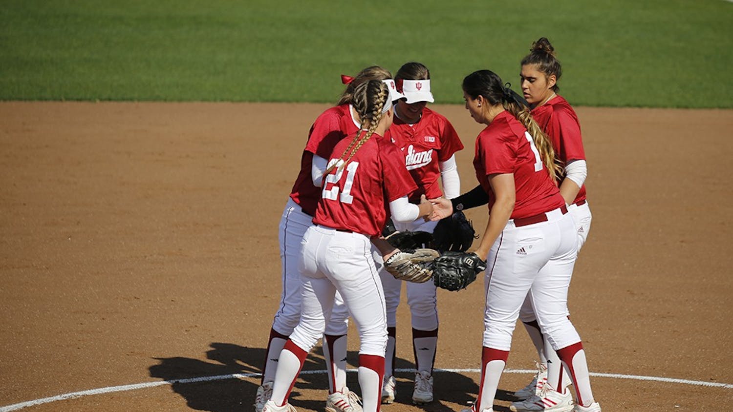 Members of the IU Softball team huddle up after Senior Pitcher Miranda Tamayo struck out an opposing player during IU's first game against Purdue Wednesday at the Andy Mohr Field. IU won 6-3 after Mena Fulton hit a 3-run home run during the last inning of the game. 