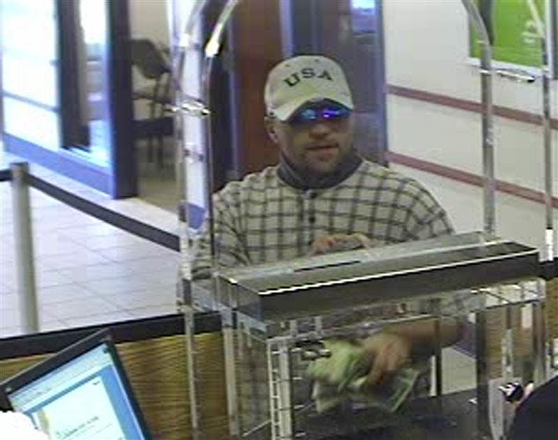 The suspect of Monday's bank robbery, pictured here from security camera footage from the west branch of the Monroe Bank, left the location with an undisclosed amount of cash. The Bloomington Police Department is still searching for the suspect.