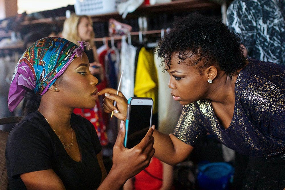 Cierra McNeal does some last minute touch ups on her model Teraira Charlton before sending her out to walk in the Indiana University Fashion Show at the Indiana Memorial Union Alumni Hall. The fashion show was produced by Retail Studies Organization and showcased the designs of IU students earning a bachelors degree in Fashion Design.