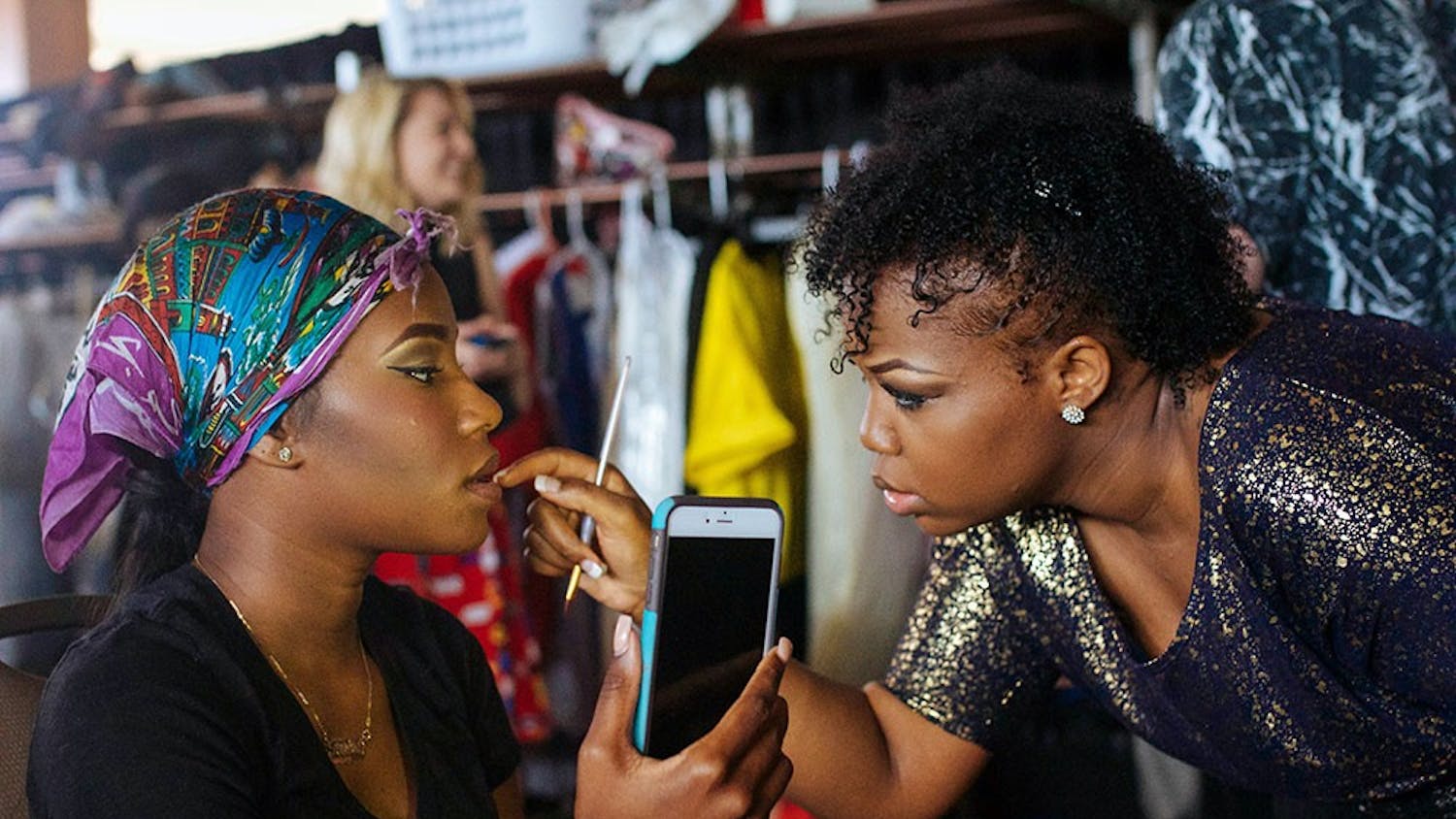 Cierra McNeal does some last minute touch ups on her model Teraira Charlton before sending her out to walk in the Indiana University Fashion Show at the Indiana Memorial Union Alumni Hall. The fashion show was produced by Retail Studies Organization and showcased the designs of IU students earning a bachelors degree in Fashion Design.