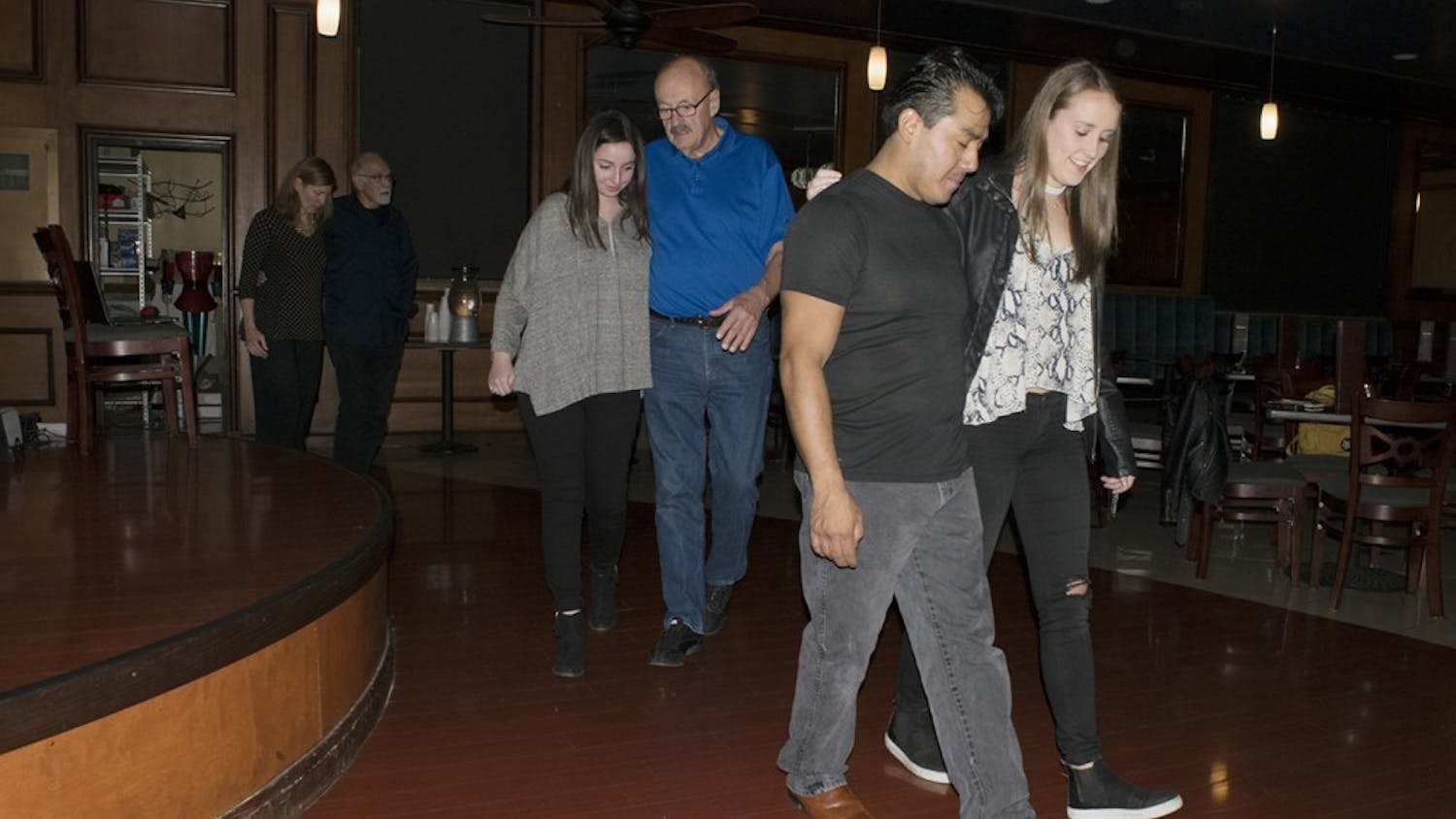 Attendees of the beginner tango class at Serendipity Martini Bar practice their walking in time to Argentine tango music Monday night. David Crosley, a guest teacher from Indianapolis, encouraged the dancers to go “inside the music.”
