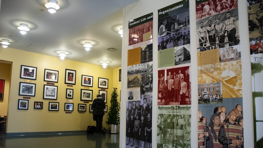 Students walk by the photographs on the walls Jan. 29, 2019, in the lobby of the Neal-Marshall Black Culture Center. The culture center will present the annual Umoja celebration virtually from Sunday to Friday.