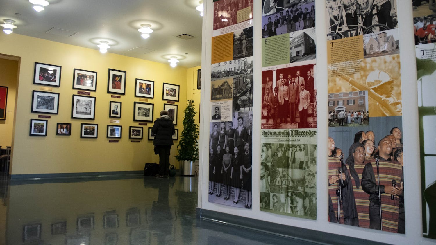 Students walk by the photographs on the walls Jan. 29, 2019, in the lobby of the Neal-Marshall Black Culture Center. The culture center will present the annual Umoja celebration virtually from Sunday to Friday.