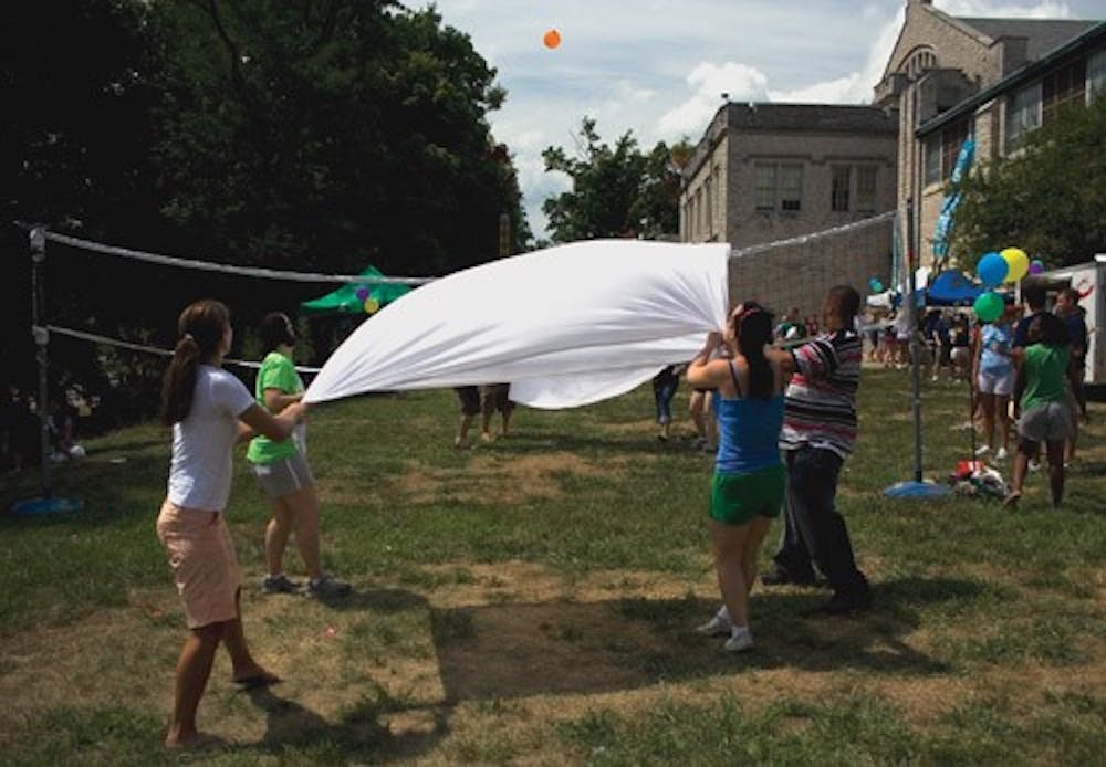 Students launch a balloon over a net during a game of water balloon volleyball at Friday’s RecFest.  The event was held outside the HPER building to orient students to various clubs and activities around campus.