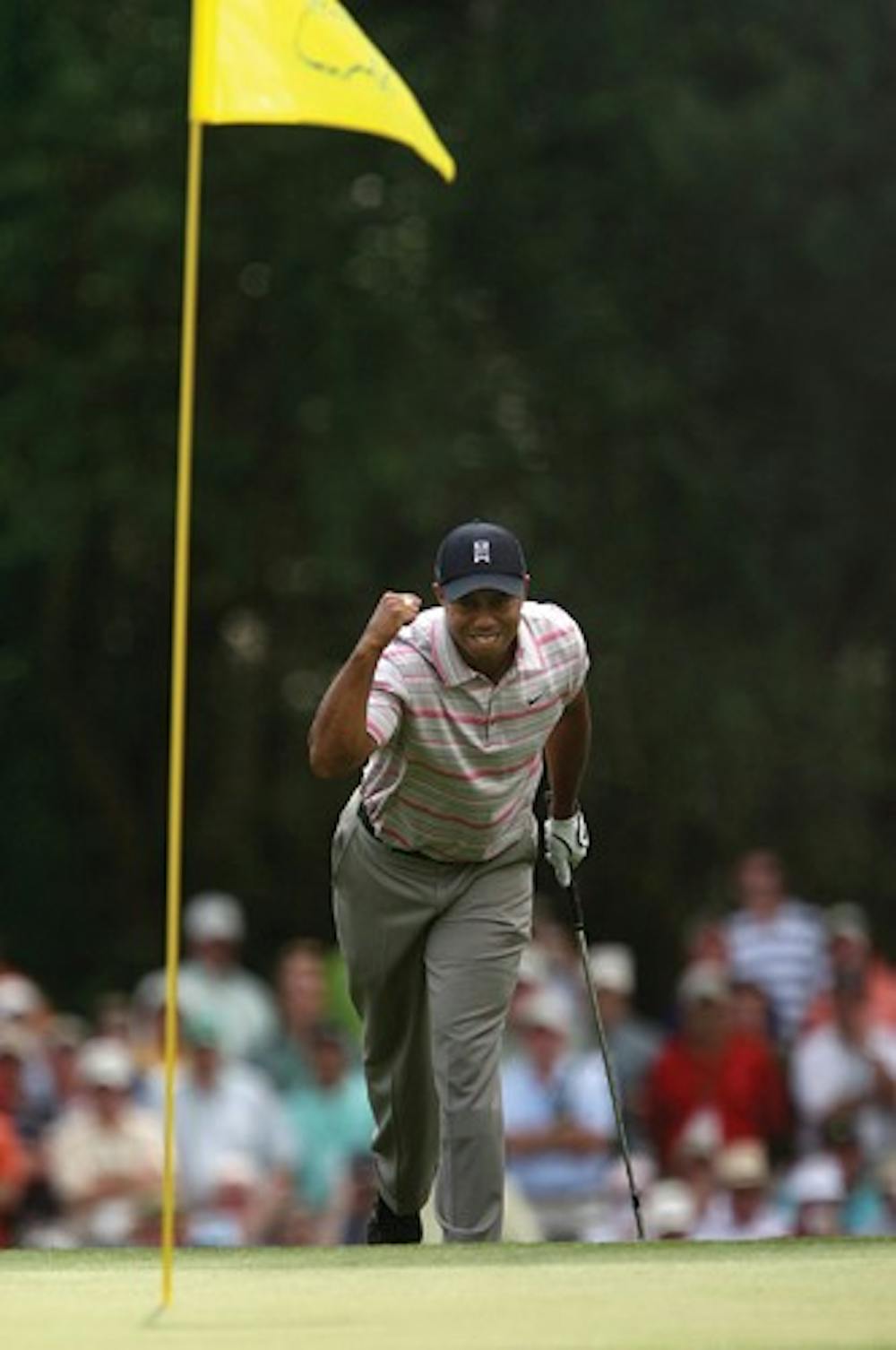 Tiger Woods pumps his fist as his ball goes in for an eagle on the 15th hole during the first round of the 2008 Masters golf tournament at the Augusta National Golf Club Thursday in Augusta, Ga. (AP Photo/Atlanta Journal-Constitution, Jason Getz) ** MARIETTA DAILY OUT, GWINNETT DAILY POST OUT **
