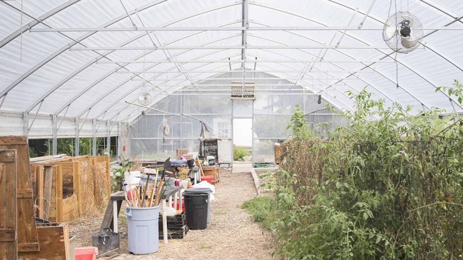 A greenhouse shelters equipment and plants at the Hilltop Garden. The garden allows students and the public to learn gardening practices and engage with nature.