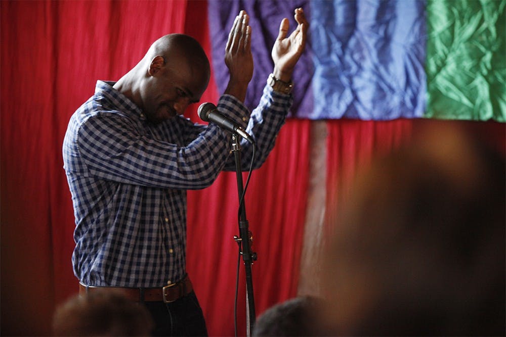 Justin Ford, board chair on the Bloomington Pride Board of Directors, starts a round of applause in celebration of the Supreme Court ruling in favor of same-sex marriage Friday.  Bloomington Pride hosted the celebration in Rachael's Cafe where dozens of local residents attended.