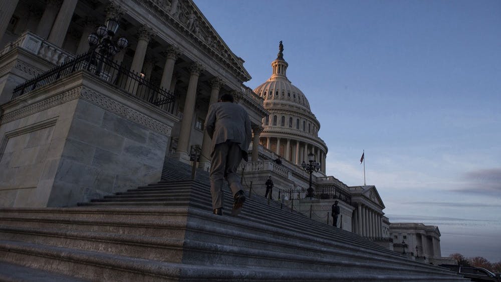 A man walks up the steps of the U.S. Capitol Building at dusk Jan. 20, 2018, in Washington, D.C. In a report sent to Congress on Friday, the Office of Management and Budget said several large federal agencies continue to be at risk for cyberattacks.