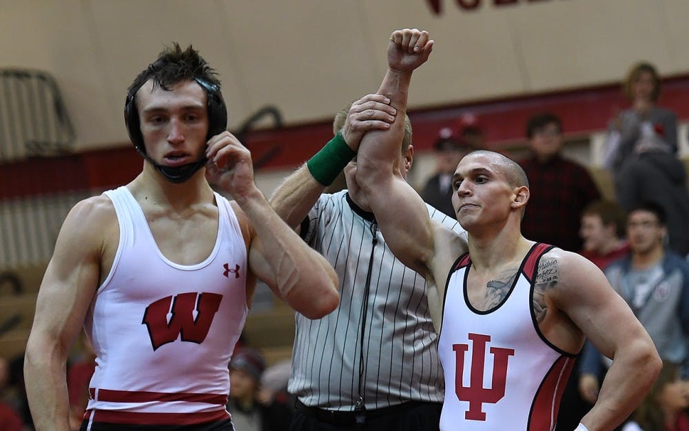 Chris Perez gets his hand raised after defeating Andrew Crone of Wisconsin on Dec. 9, 2016. Perez hopes to get a win&nbsp;again on Friday against Iowa.