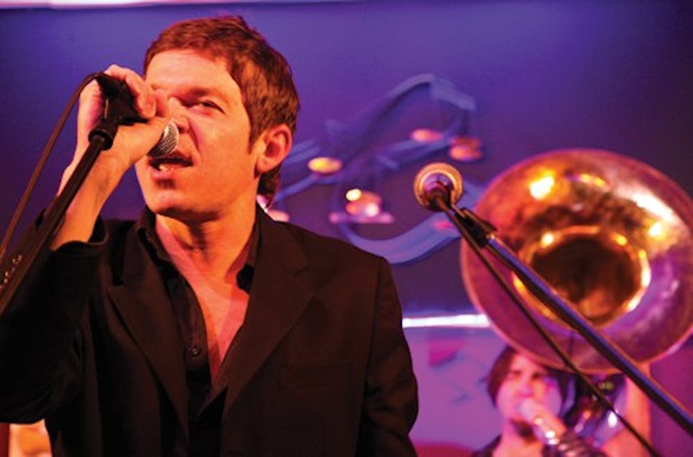 Mark Mullins takes a break from playing trombone to sing during a Bonerama show Tuesday evening at the Players Pub. Mullins is the singer and co-founder of the band, which is from New Orleans.