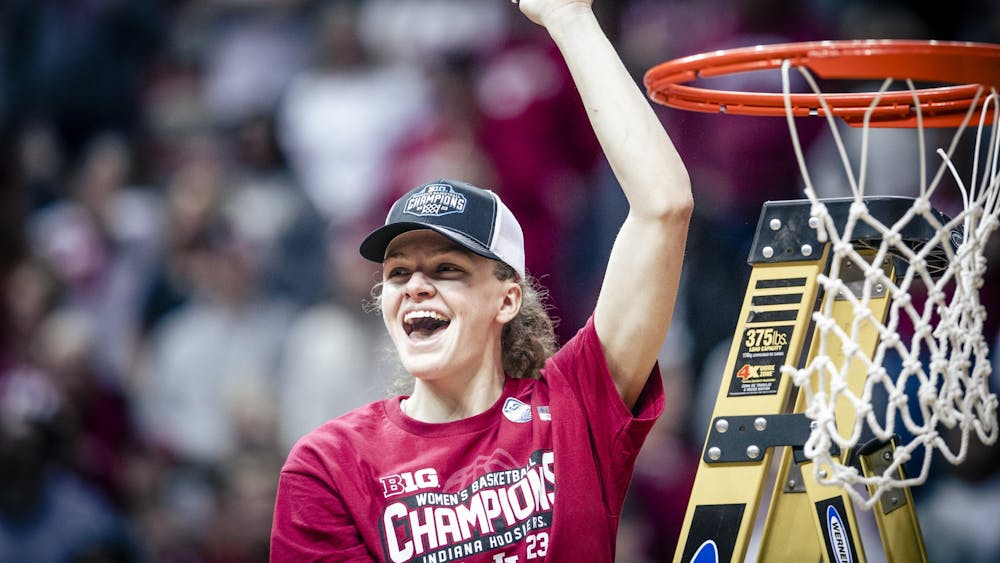 Senior guard Grace Berger celebrates after cutting the net Feb. 19, 2023, at Simon Skjodt Assembly Hall in Bloomington. Indiana beat Purdue 83-60 to win a share of the regular season Big Ten title.