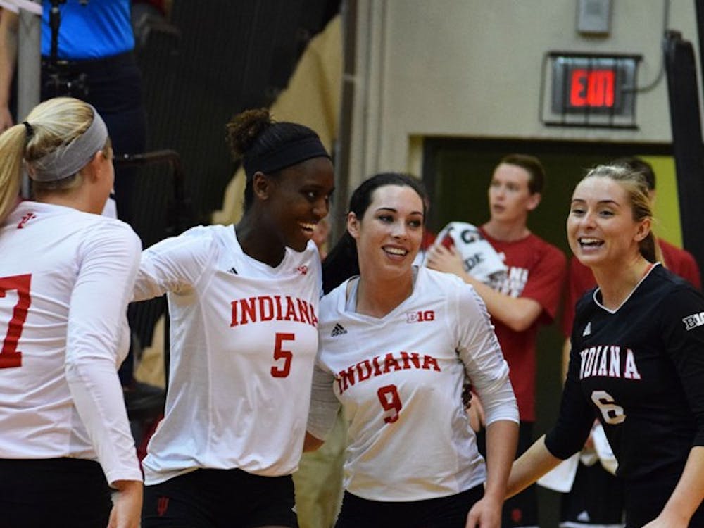 Jazzmine McDonald, Megan Tallman, and Taylor Lebo are all smiles after #5 gets an ace that sends the Hoosiers ahead of the Gophers.