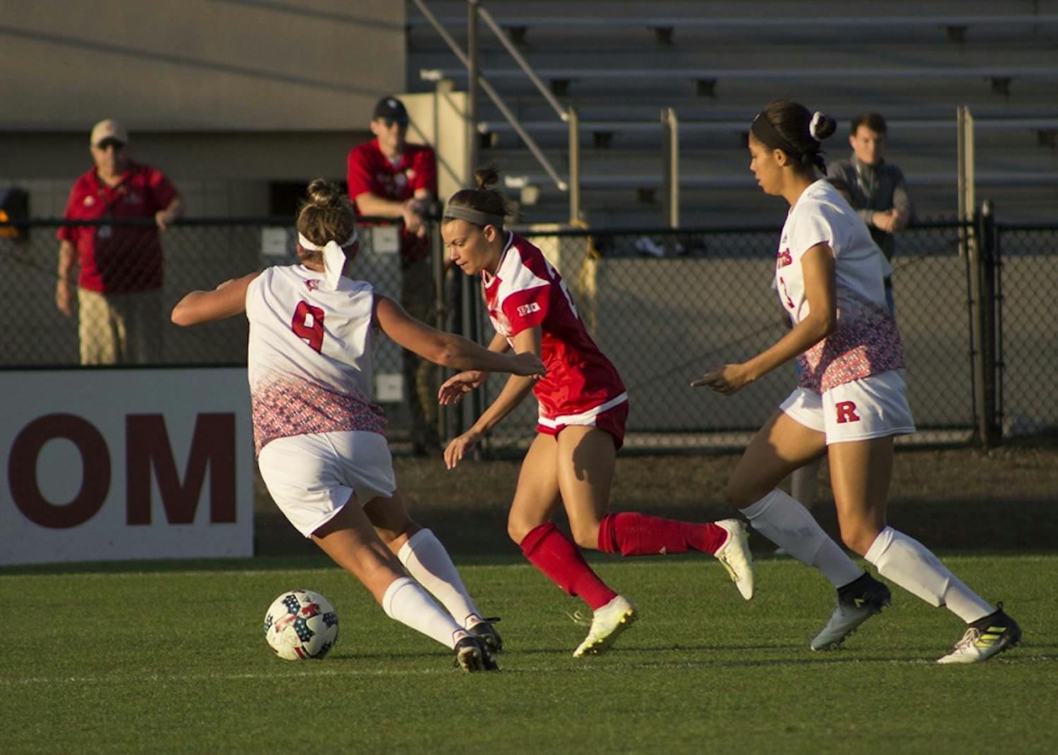Sophomore midfielder Sydney Kilgore controls the ball under pressure from two defenders against Rutgers Saturday night. IU lost 1-0 in overtime to Rutgers at Bill Armstrong Stadium.