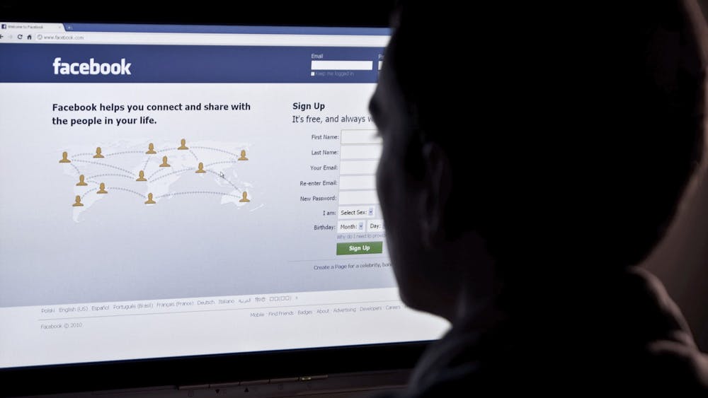 A person looks at the Facebook login screen. A California state senator proposed requiring social media sites such as Facebook to remove videos and photographs of crimes posted by alleged perpetrators when a request is made by victims.